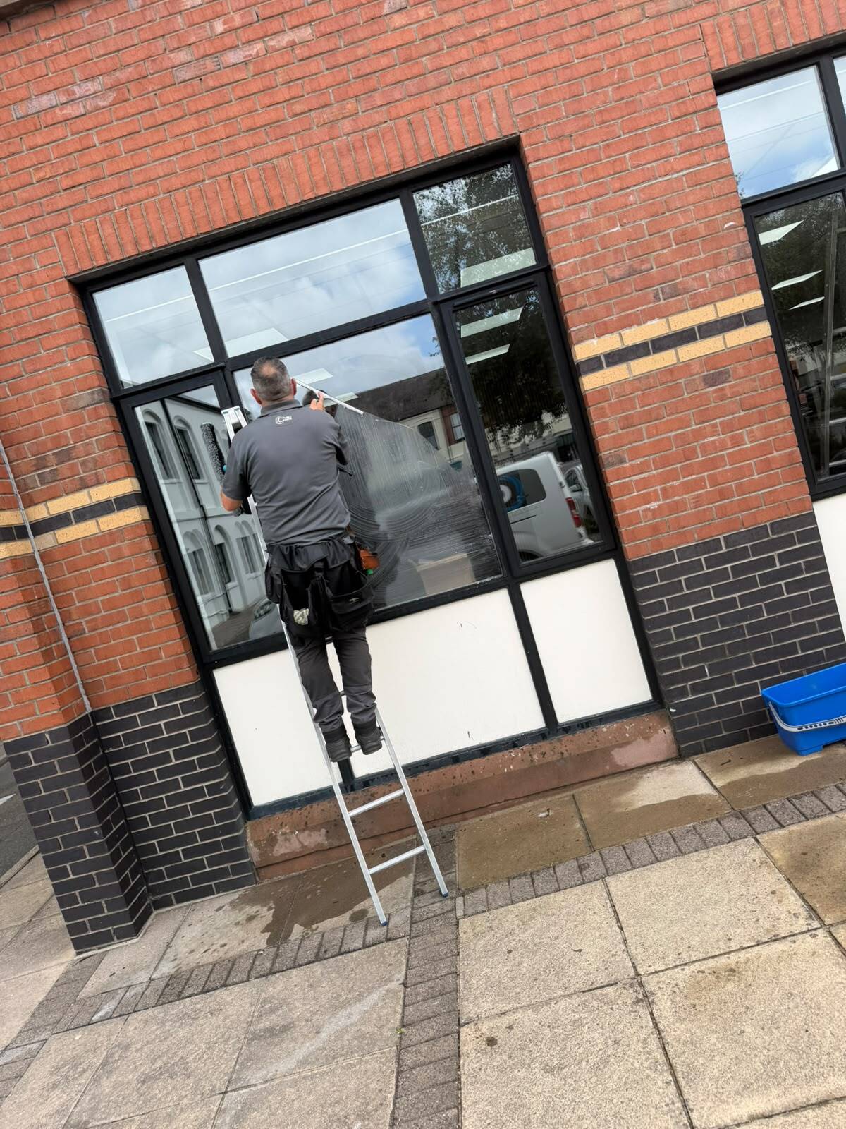 Commercial window cleaner cleaning office windows
